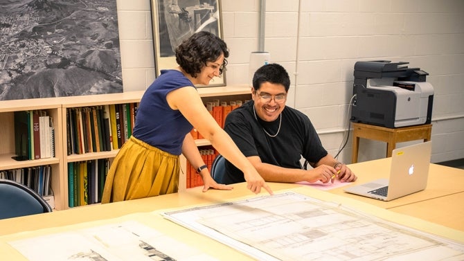 Student points to collection on large table