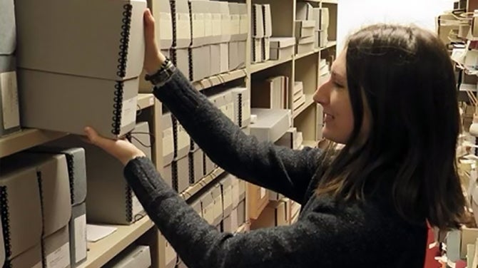 Student pulls library collection from shelving