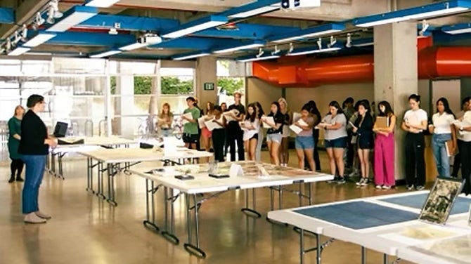 Individual speaks with large group of students