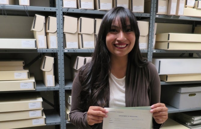 Student holds archive document