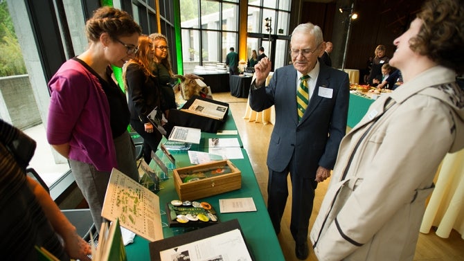 People gather and view university archive records
